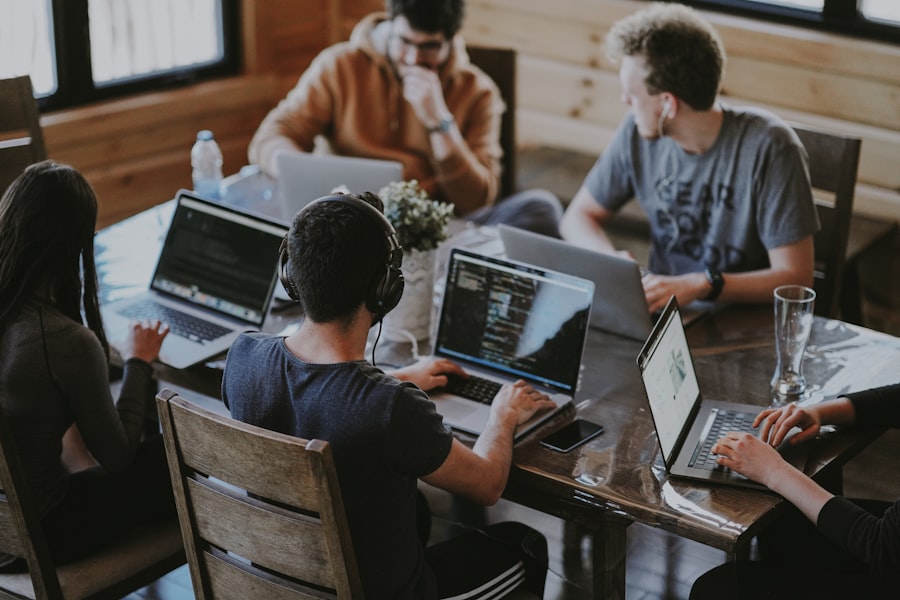 Development team collaborating together around a laptop in a modern workspace